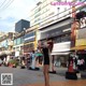 A woman standing in the middle of a busy city street.