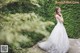 A woman in a wedding dress posing for a picture.