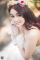 A woman in a wedding dress posing for a picture.