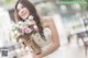 A woman in a wedding dress holding a bouquet of flowers.