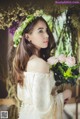 A woman in a white dress holding a bouquet of flowers.