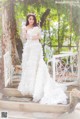 A woman in a wedding dress posing for a picture.