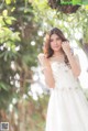 A woman in a wedding dress posing for a picture.