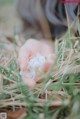 A person holding a small white flower in their hand.