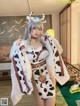 A woman in a cow costume posing for a picture.