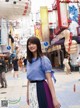 A woman standing in the middle of a city street.